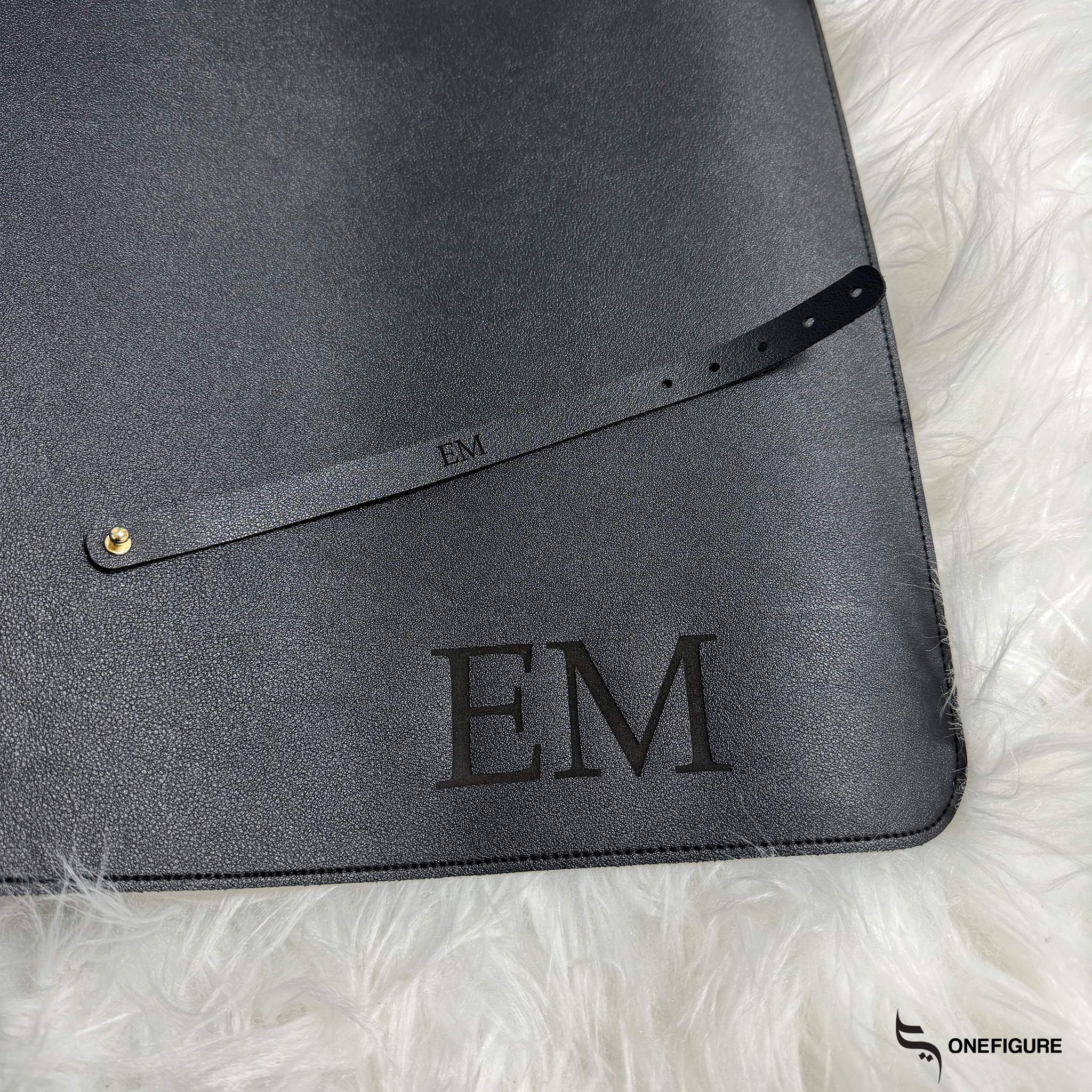 a black folder with a name engraved on it